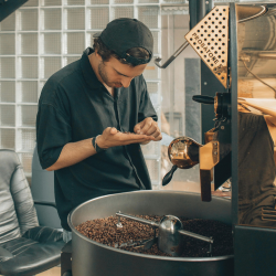 A person grinding coffee beans